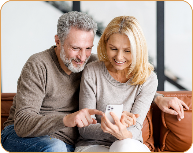 happy-senior-couple-with-smartphone-couch-spends-leisure-time-social-network